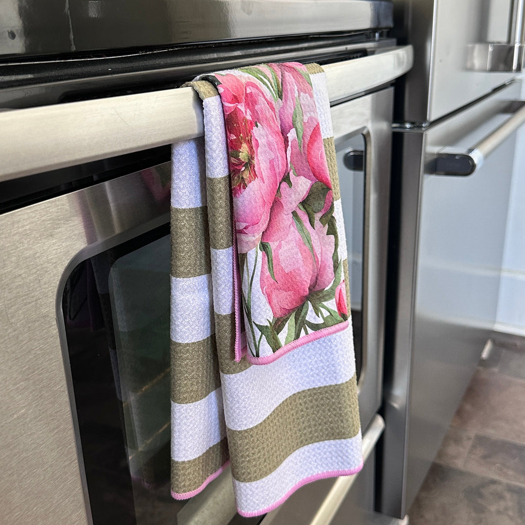 Stainless steel oven with a floral towel hanging on the handle